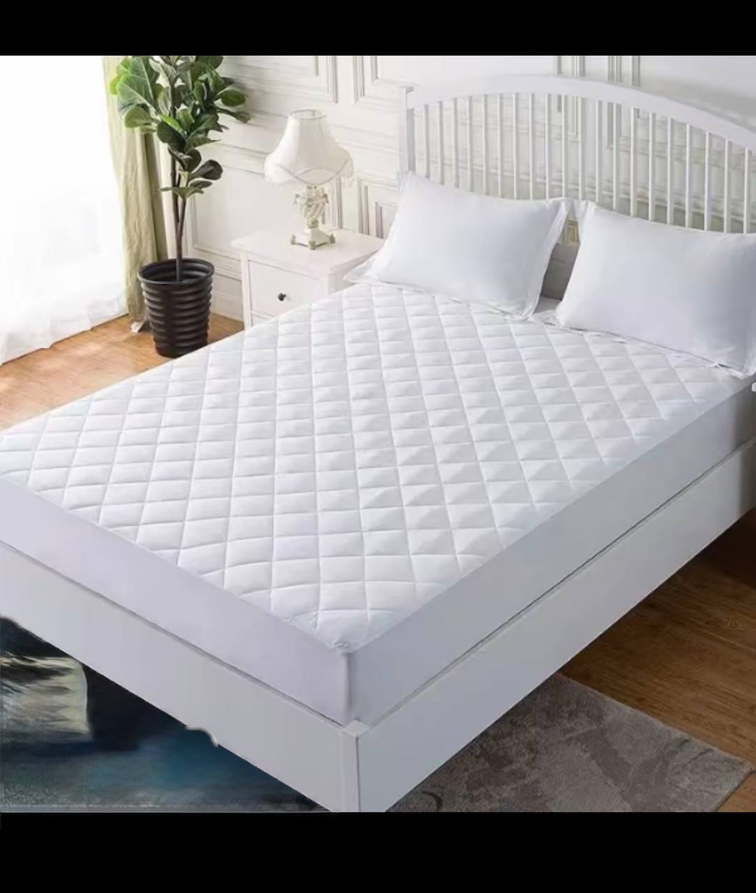QMP quilted mattress protector fitted on bed